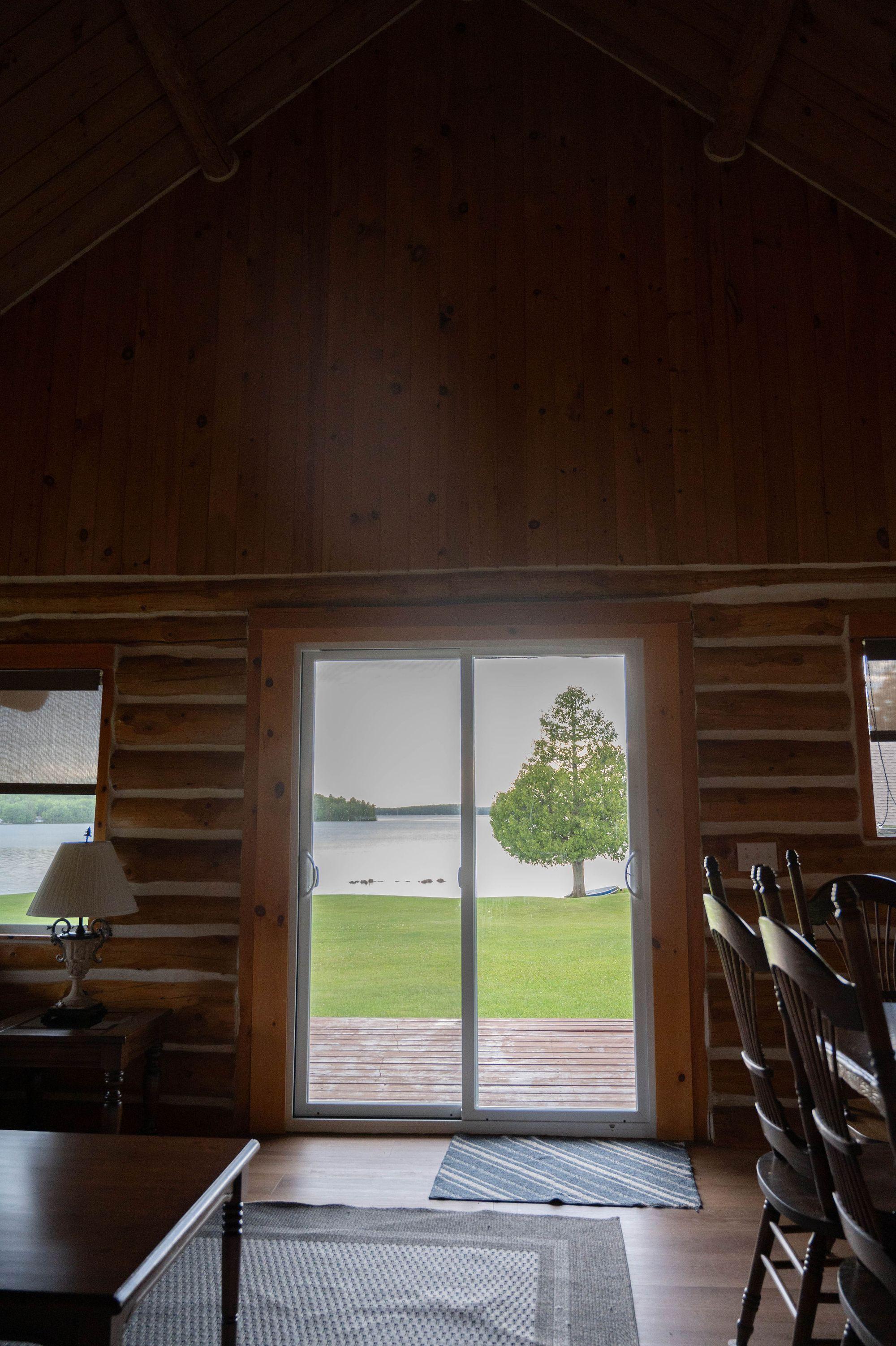 Living room with sliding doors open to the lake