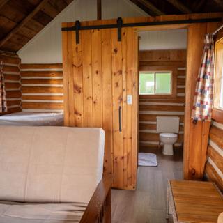 Living room with log walls and view of the lake